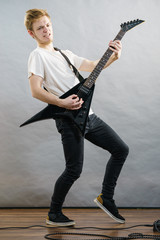 Fototapeta premium Man playing on electric guitar