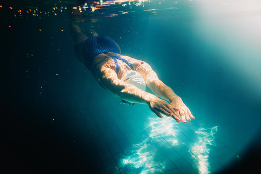 Female Swimmer At The Swimming Pool.Underwater Photo.