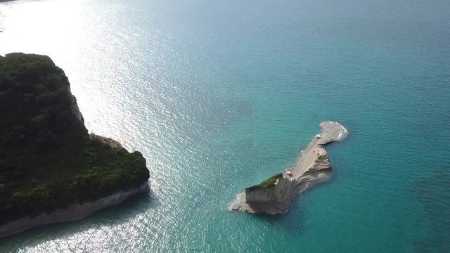 Aerial drone video of iconic white rock steep cliff volcanic bay of Cape Drastis and Peroulades area with tropical deep turquoise clear sea, Corfu island, Ionian, Greece