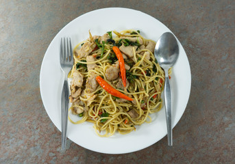Have lunch break. Spaghetti spicy seafood on stone floor table, Food concept.