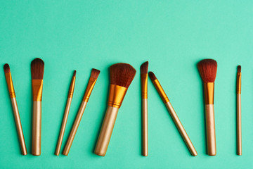 Makeup brushes, everyday make-up tools. Cosmetic essentials on bright background, flat lay.