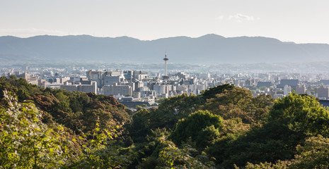 Kyoto city on sunset in Kyoto, Japan. The view from Kiyomizu-dera temple see Kyoto tower and the whole city, includes mountain range on background. 