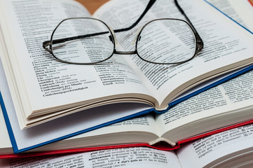 Closeup of Reading Glasses on Book 