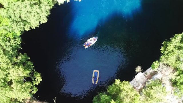 Aerial drone top view video of iconic open cave and lake of Melissani near port of Sami, Cefalonia island, Ionian, Greece