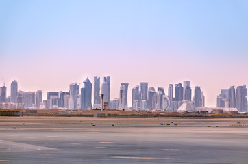 Doha skyline. Cityscape of Qatar capital. View from airport. Futuristic urban landscape of Doha.