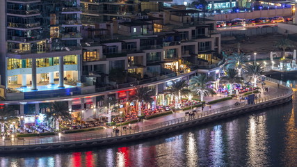 Luxury Dubai Marina canal with passing boats and promenade night timelapse, Dubai, United Arab Emirates © HyperlapsePro