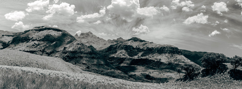 A black and white panoramic landscape of a mountain range scene