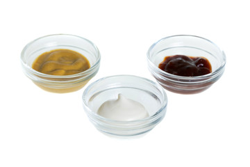 Bowls with sauces isolated on white background