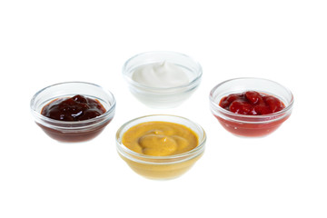 Bowls with sauces isolated on white background