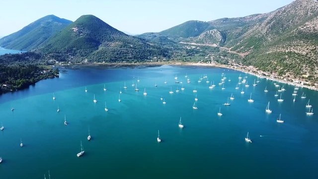 Aerial drone bird's eye view video of iconic port of Nidri or Nydri a safe harbor for sail boats and famous for trips to Meganisi, Skorpios and other Ionian islands, Lefkada island, Ionian, Greece
