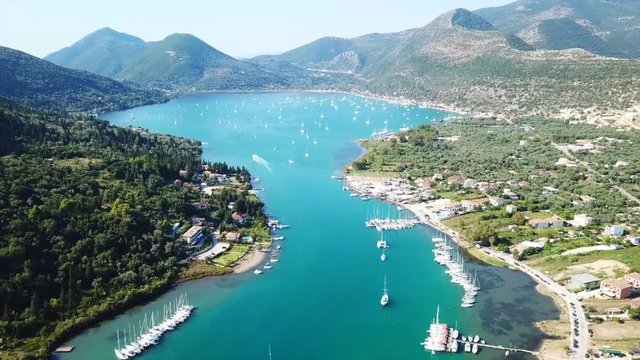 Aerial drone bird's eye view video of iconic port of Nidri or Nydri a safe harbor for sail boats and famous for trips to Meganisi, Skorpios and other Ionian islands, Lefkada island, Ionian, Greece