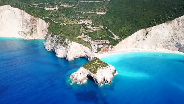 Aerial drone video of popular tropical paradise deep turquoise beach of Porto Katsiki with white steep rocky seascape and beautiful cloudy landscape, Lefkada island, Ionian, Greece