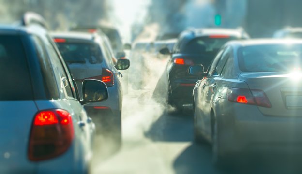 pollution from the exhaust of cars in the city in the winter. Smoke from cars on a cold winter day