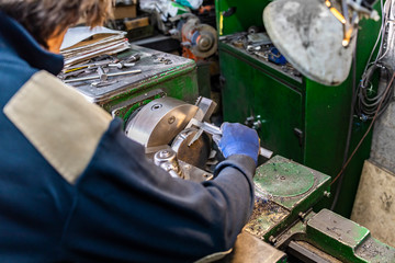 Worker measuring with a caliper a piece
