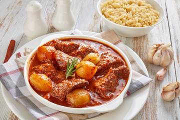 stifado - beef stew in a bowl served with risoni