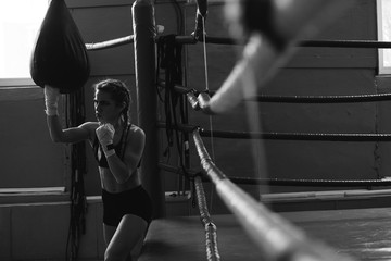 Fitness woman with the white boxing bandages. Attractive Female Boxer Training.female MMA fighter punching.