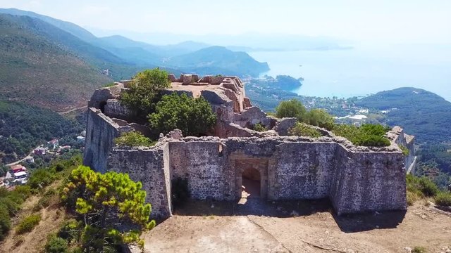 Aerial drone video of iconic castle of Ali Pasha overlooking bay and village of Parga, Epirus, Ionian, Greece