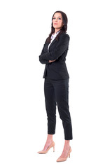 Side view of confident successful female business manager with crossed arms looking at camera. Full body isolated on white background. 