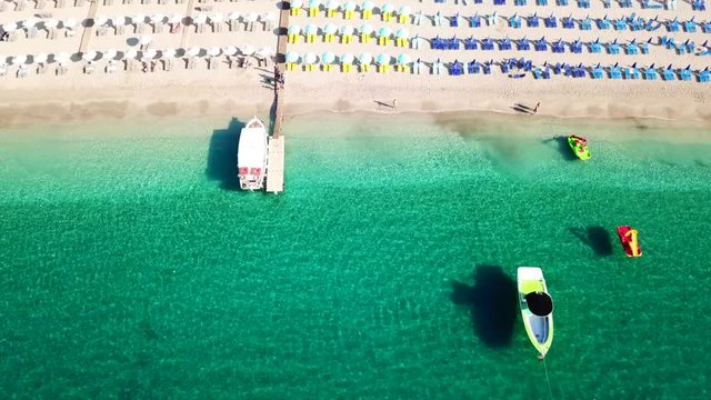 Aerial drone video of natural beauty bay and sandy beach of Valtos with watersports facilities and emerald sea. Parga, Epirus