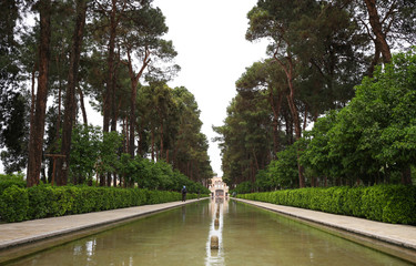 Water pool with garden and trees around in a ancient dowlat-abad garden in Yazd, Iran