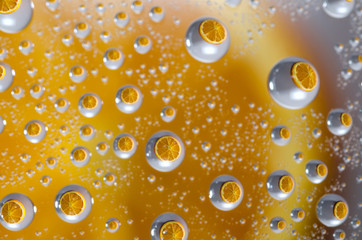 Reflected Orange Fruit in Water Drops.