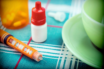 Medication during breakfast, dispenser of insulin, conceptual Image, horizontal composition