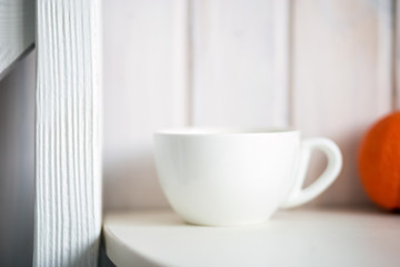 Fototapeta na wymiar White mug on kitchen table
