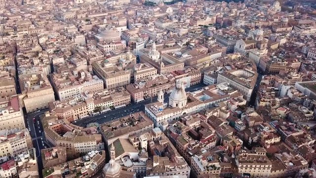 Aerial drone video of iconic landmark Piazza Navona (Square) featuring Fountain of the Four Rivers with an Egyptian obelisk and Sant Agnese Church in the heart of Rome, Italy