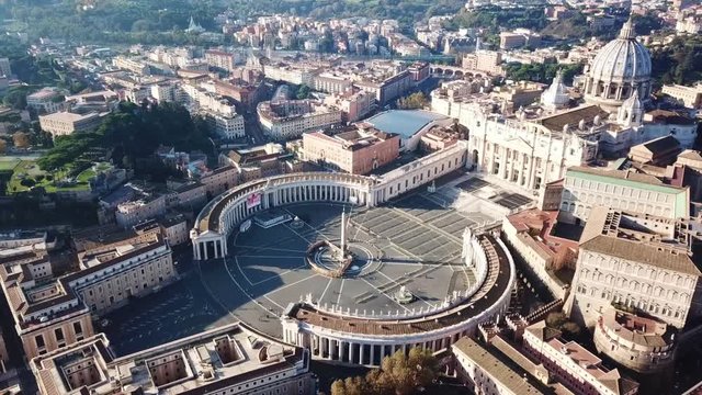 Aerial drone video of Saint Peter's square in front of world's largest church - Papal Basilica of St. Peter's, Vatican - an elliptical esplanade created in the mid seventeenth century, Rome, Italy