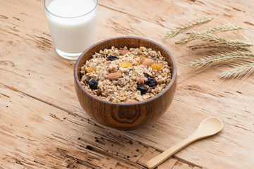 Mixed Muesli with a glass of Milk on wooden background