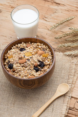 Mixed Muesli with a glass of Milk on wooden background