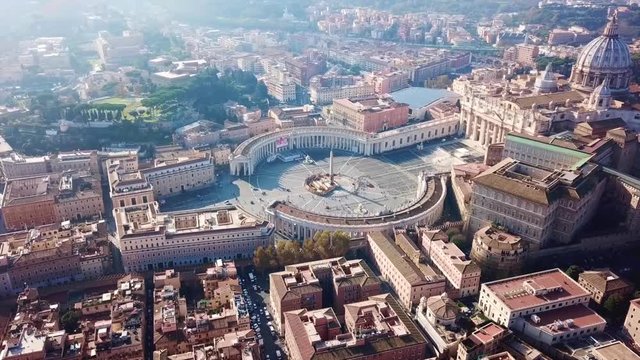 Aerial drone video of Saint Peter's square in front of world's largest church - Papal Basilica of St. Peter's, Vatican - an elliptical esplanade created in the mid seventeenth century, Rome, Italy