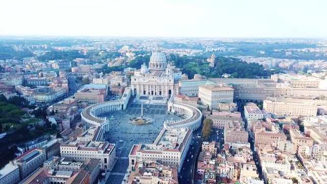 Aerial drone video of Saint Peter's square in front of world's largest church - Papal Basilica of St. Peter's, Vatican - an elliptical esplanade created in the mid seventeenth century, Rome, Italy