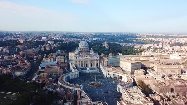 Aerial drone video of Saint Peter's square in front of world's largest church - Papal Basilica of St. Peter's, Vatican - an elliptical esplanade created in the mid seventeenth century, Rome, Italy