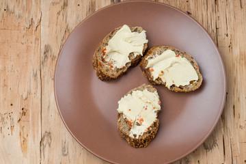 Lentil hummus on bread in clay plate