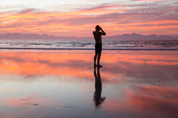 Senior man preparing to swim in the sea at dawn