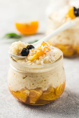 Creamy vanilla rice pudding with citrus jelly and berries. Selective focus, space for text.