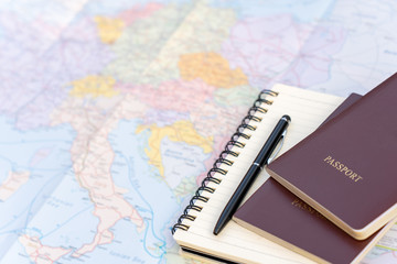 Passport on Europe map background.Travel planning.Top view of traveler accessories with two passports, notebook on world map.Preparation for travel.Traveling Journey Vacation Holiday concept.