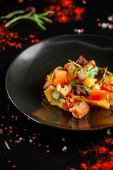The concept of Spanish cuisine. Spanish salad with chorizo sausage, orange, tomato, baguette, tarragon, olive oil. A glass of cool wine on the table. background image. copy space