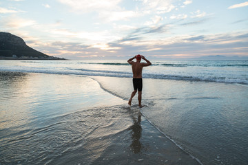 Senior man preparing to swim in the sea at dawn
