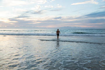Senior man preparing to swim in the sea at dawn