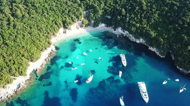 Aerial drone bird's eye view video of famous sandy beach and small island of Agia Paraskevi with emerald clear sea, Sivota, Thesprotia, Epirus, Greece