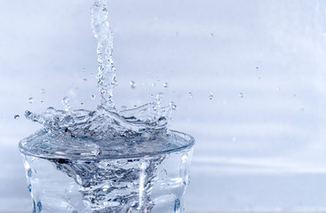 Naklejka na ściany i meble Close up of Water Splashing in a Glass