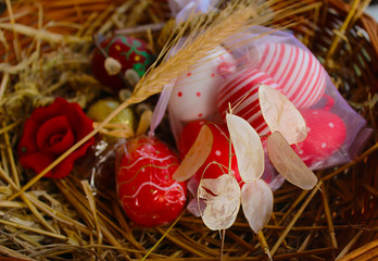 Walnuts, church bells and red Easter eggs in a wooden basket