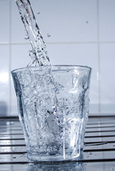 Water Splashing into a Clear Glass