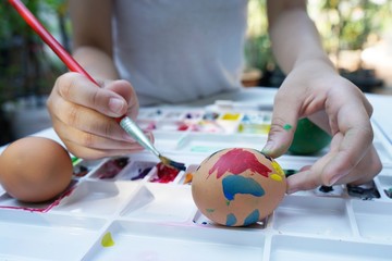 Colorful easter eggs painting activity with color tray background, fun event for kid concept