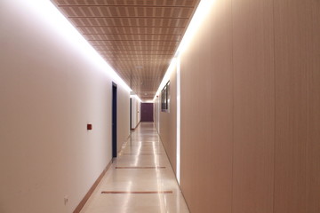 White and cream colored illuminated long corridor