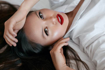 Beauty face makeup. Beautiful woman with black hair and red lips