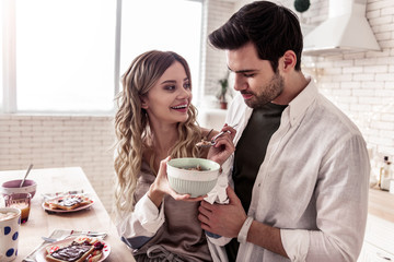 Pretty long-haired young woman in a white shirt and her husband laughing together