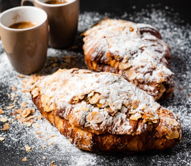 Croissants with almonds on the black background